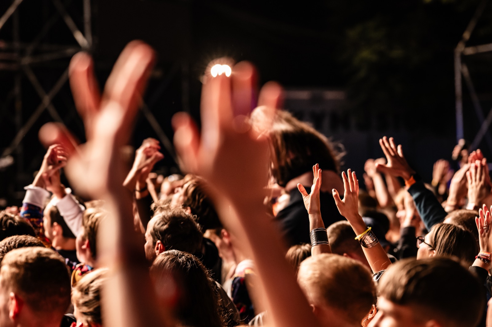 Crowd with hands raised at a concert