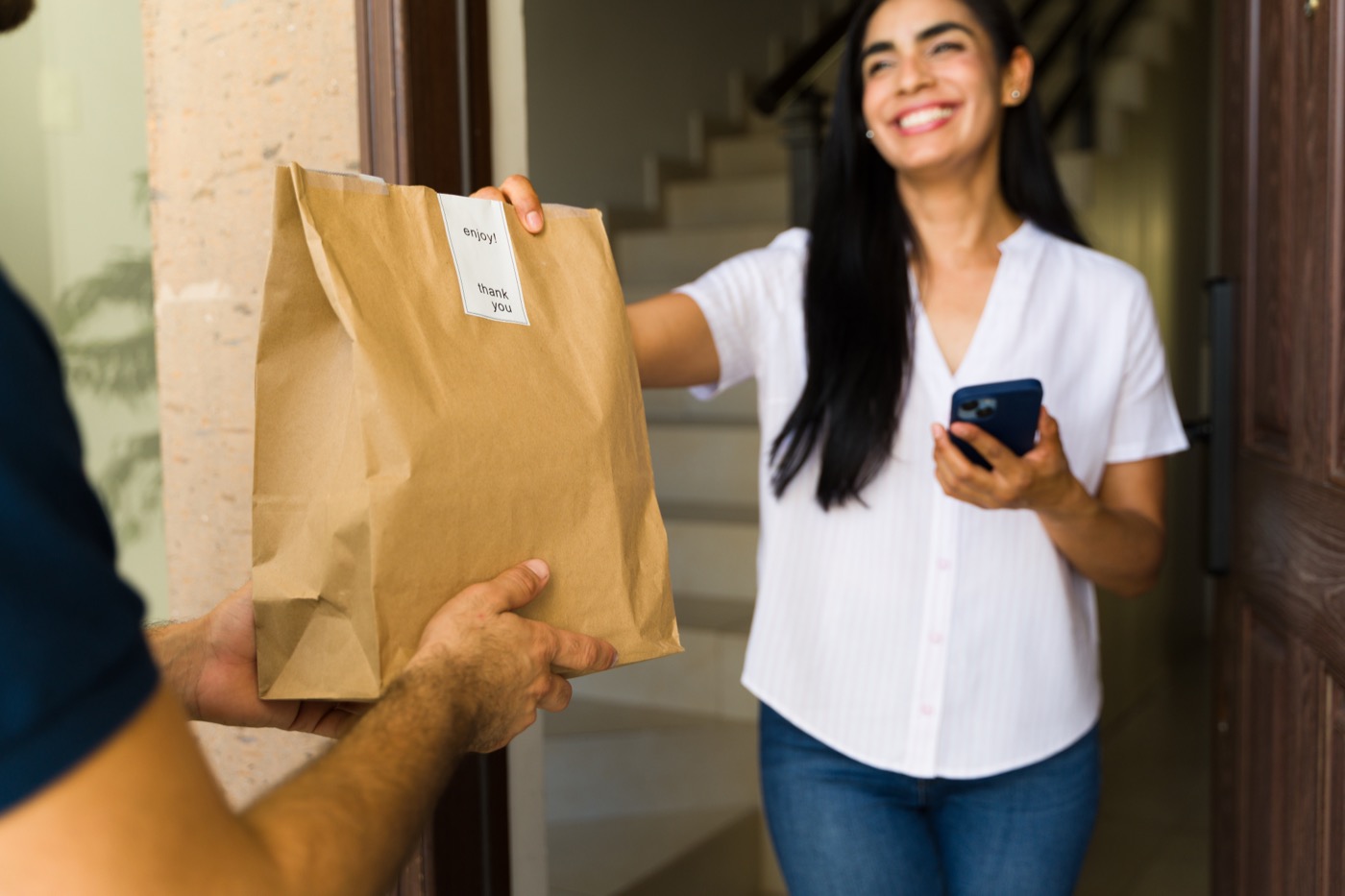 Food delivery courier handing over an order